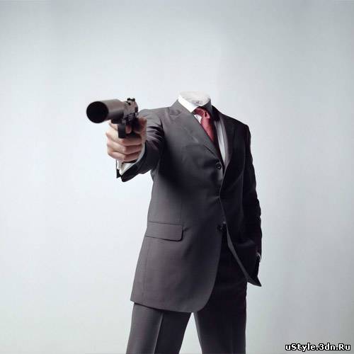 Мужчина в костюме с пистолетом
